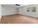 A bright living room with hardwood flooring, a ceiling fan, and an inviting front door at 404 Courtney Dr, Temple Terrace, FL 33617