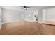 Open living room with modern flooring, neutral walls, ceiling fan and doorway to the kitchen at 404 Courtney Dr, Temple Terrace, FL 33617
