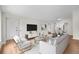 Stylishly decorated living room that is open to the dining area, featuring hardwood floors and neutral paint at 404 Courtney Dr, Temple Terrace, FL 33617
