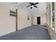 Spacious screened porch featuring a ceiling fan and black exterior door at 404 Courtney Dr, Temple Terrace, FL 33617