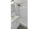 Clean white bathroom with updated vanity, mirror and shower at 7604 Tyson Dr, Port Richey, FL 34668
