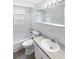 Clean bathroom featuring a vanity with solid surface countertop, bathtub and tiled walls at 7604 Tyson Dr, Port Richey, FL 34668