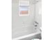 Bright white bathroom with a soaking tub and a window allowing for natural light at 7604 Tyson Dr, Port Richey, FL 34668