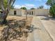 Charming home exterior showcasing the front yard, driveway, and landscaping under a sunny sky at 7604 Tyson Dr, Port Richey, FL 34668