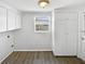 Convenient laundry room features ample cabinet space and new laminate flooring at 7604 Tyson Dr, Port Richey, FL 34668