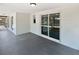 Covered back patio with sliding doors leading into the home, offering an outdoor space for relaxing at 7604 Tyson Dr, Port Richey, FL 34668