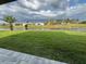 Picturesque backyard view with a well-maintained lawn extending to a serene canal at 9 Bunker Pl, Rotonda West, FL 33947