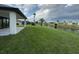Expansive backyard featuring lush grass, a canal, and palm trees at 9 Bunker Pl, Rotonda West, FL 33947