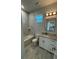 This stylish bathroom includes a tub, shower, granite vanity, and updated lighting at 9 Bunker Pl, Rotonda West, FL 33947