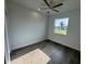 This bright bedroom features a ceiling fan and view of the neighborhood at 9 Bunker Pl, Rotonda West, FL 33947