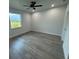 This spacious bedroom features sleek wood floors and a modern ceiling fan at 9 Bunker Pl, Rotonda West, FL 33947