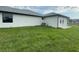 Exterior view of home featuring an AC unit and a lush lawn at 9 Bunker Pl, Rotonda West, FL 33947