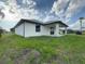 Modern home exterior showcasing a well-manicured lawn and a covered patio at 9 Bunker Pl, Rotonda West, FL 33947