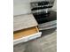 Modern kitchen with white cabinetry, stainless steel appliances and stone countertops at 9 Bunker Pl, Rotonda West, FL 33947