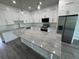 Bright kitchen featuring white cabinets, stainless steel appliances, and a stone countertop island at 9 Bunker Pl, Rotonda West, FL 33947