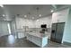 Beautiful kitchen featuring white cabinetry, stainless appliances, and a large center island with countertops at 9 Bunker Pl, Rotonda West, FL 33947