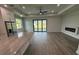 Bright living room featuring hardwood floors, sliding glass doors, modern lighting, and neutral walls at 9 Bunker Pl, Rotonda West, FL 33947