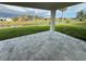 Relaxing backyard stone patio overlooking a tranquil canal and lush green lawn at 9 Bunker Pl, Rotonda West, FL 33947