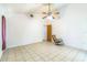 Spacious bedroom with tile floors, ceiling fan, and a view to the entryway at 18430 Alphonse Cir, Port Charlotte, FL 33948