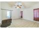 Empty bedroom with tile floors, features a sliding door that leads to an outside balcony at 18430 Alphonse Cir, Port Charlotte, FL 33948