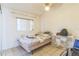 Bright bedroom with tile flooring, a window, and a ceiling fan at 18430 Alphonse Cir, Port Charlotte, FL 33948