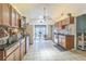 Kitchen with wood cabinets, granite countertops, tile flooring, and stainless steel appliances at 18430 Alphonse Cir, Port Charlotte, FL 33948