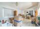 Living room filled with boxes, showing tile flooring, natural light, and potential layout at 18430 Alphonse Cir, Port Charlotte, FL 33948