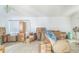 Bright living room filled with boxes and furniture, featuring tile floors and a large window at 18430 Alphonse Cir, Port Charlotte, FL 33948