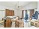 View of a living room with a ceiling fan, curtains and a sliding door to the outside at 18430 Alphonse Cir, Port Charlotte, FL 33948
