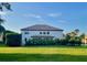 Expansive backyard with lush lawn and privacy hedge, providing a serene outdoor retreat at 302 Coco Plum Ct, Oldsmar, FL 34677