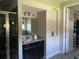 Stylish bathroom boasts a glass shower, a granite vanity, neutral paint, and an attached closet at 302 Coco Plum Ct, Oldsmar, FL 34677