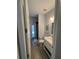 Hall bathroom with white vanity, grey walls, modern sink, toilet and decorative art at 302 Coco Plum Ct, Oldsmar, FL 34677