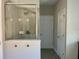 Bathroom features a modern glass shower with gray tiling and updated fixtures at 302 Coco Plum Ct, Oldsmar, FL 34677