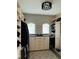 Walk-in closet with custom shelving, cabinets, and a center island for accessories at 302 Coco Plum Ct, Oldsmar, FL 34677