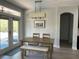 Dining room with table, bench and chairs next to doorway to outdoors at 302 Coco Plum Ct, Oldsmar, FL 34677