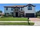 Charming two-story home with a tile roof, stone accents, well-manicured lawn, and a two car garage at 302 Coco Plum Ct, Oldsmar, FL 34677