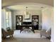 Inviting home office with dark wood desk, bookshelves, neutral chairs, and natural light at 302 Coco Plum Ct, Oldsmar, FL 34677