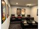 Comfortable home theater boasts tiered seating and movie-themed decor at 302 Coco Plum Ct, Oldsmar, FL 34677