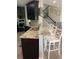 Open concept kitchen with granite countertops, a breakfast bar, and dark wood cabinetry at 302 Coco Plum Ct, Oldsmar, FL 34677