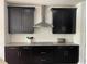 Modern kitchen with sleek black cabinets, subway tile backsplash, and stainless steel appliances at 302 Coco Plum Ct, Oldsmar, FL 34677