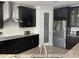 Stylish kitchen with black cabinets, granite countertops, stainless steel appliances, and a pantry door at 302 Coco Plum Ct, Oldsmar, FL 34677