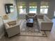 Bright living room featuring modern furniture, large windows, and a view of the backyard pool at 302 Coco Plum Ct, Oldsmar, FL 34677