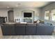 Bright living area with a sectional sofa, media console, adjacent staircase and large windows for plenty of sunlight at 302 Coco Plum Ct, Oldsmar, FL 34677