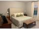 Main bedroom features large bed, neutral colors, and bright natural light at 302 Coco Plum Ct, Oldsmar, FL 34677