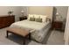 Main bedroom features a neutral color palette, bench, and two side tables at 302 Coco Plum Ct, Oldsmar, FL 34677