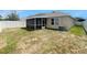 Backyard featuring a screened in porch and ample outdoor space at 10956 Carlton Fields Dr, Riverview, FL 33579
