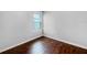 Bedroom featuring gleaming hardwood floors and a bright window view at 10956 Carlton Fields Dr, Riverview, FL 33579