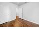 A bright bedroom with hardwood floors with an entrance to an ensuite bathroom at 10956 Carlton Fields Dr, Riverview, FL 33579