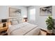 Well-lit bedroom with plush bedding, stylish decor, and light hardwood flooring at 10956 Carlton Fields Dr, Riverview, FL 33579