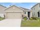 Charming single-Gathering home featuring a two-car garage and well-maintained front lawn at 10956 Carlton Fields Dr, Riverview, FL 33579